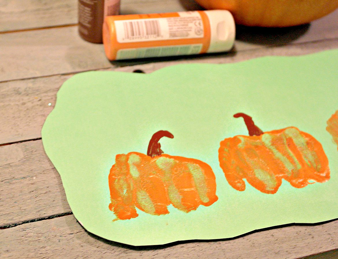 making fist pumpkins with paint on construction paper.