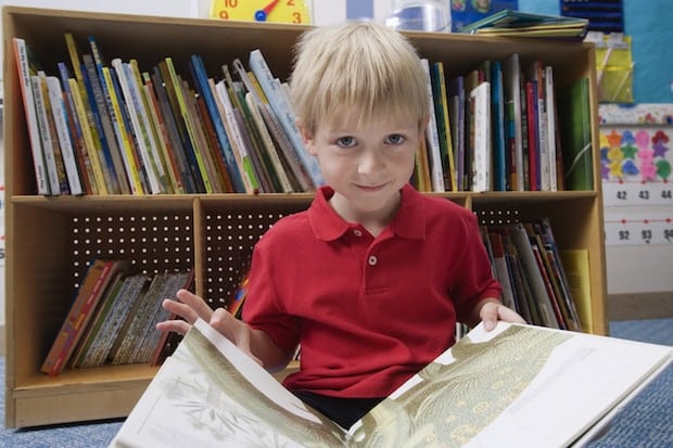 Child at Library Holding Book