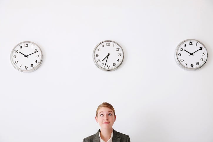 white woman woman looking at office clock