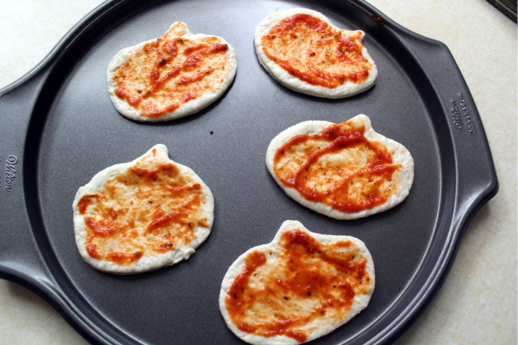 pumpkin shaped dough with pizza sauce
