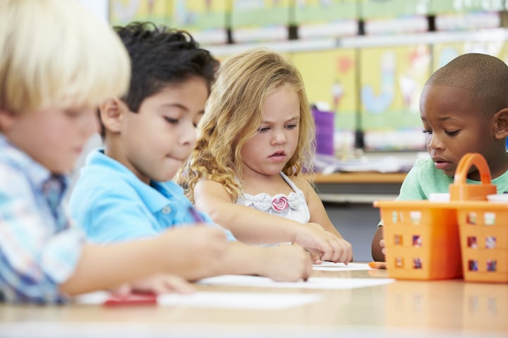 Children Coloring with Crayons