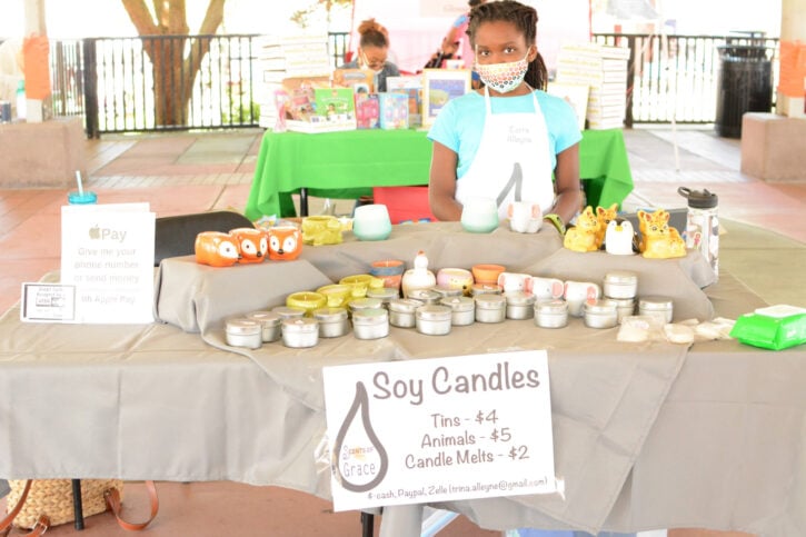 Girl with Face Mask Selling Soy Candles at Acton Children's Business Fair