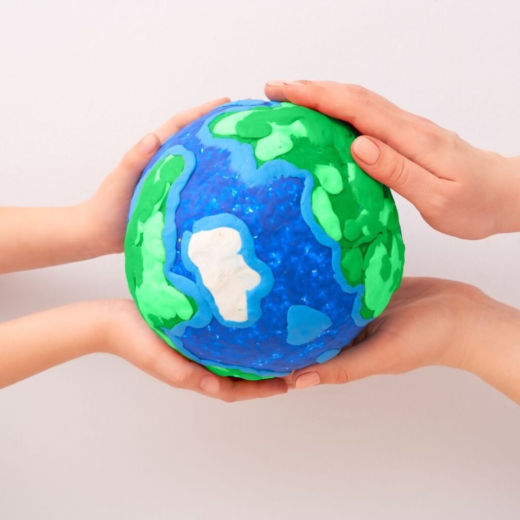 Earth Day hands holding globe
