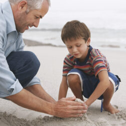 father and son playing on beach