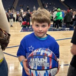 Young boy with Harlem Globetrotters basketball.