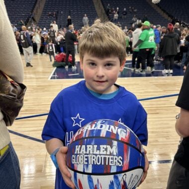 Young boy with Harlem Globetrotters basketball.