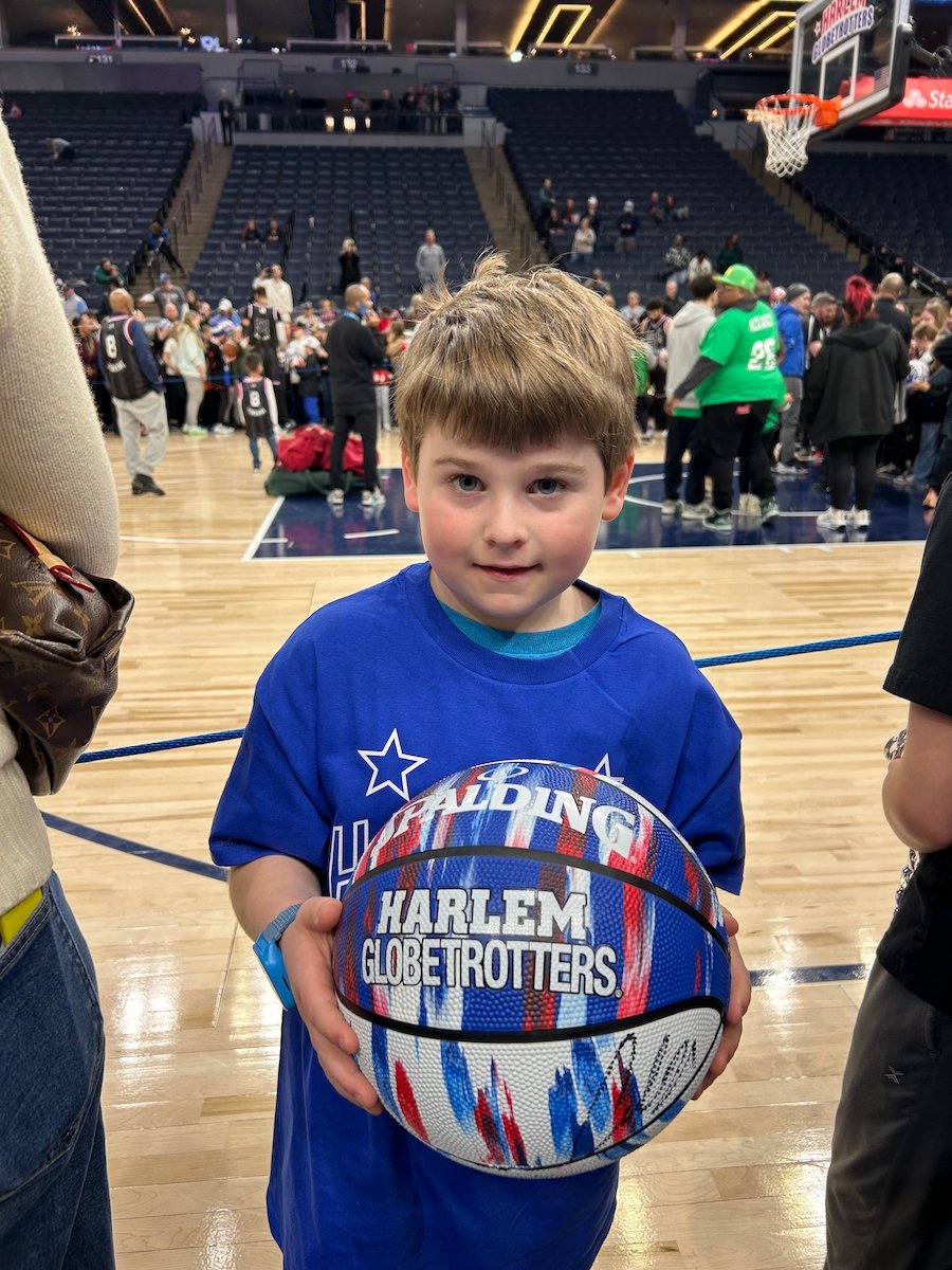 Young boy with Harlem Globetrotters basketball.